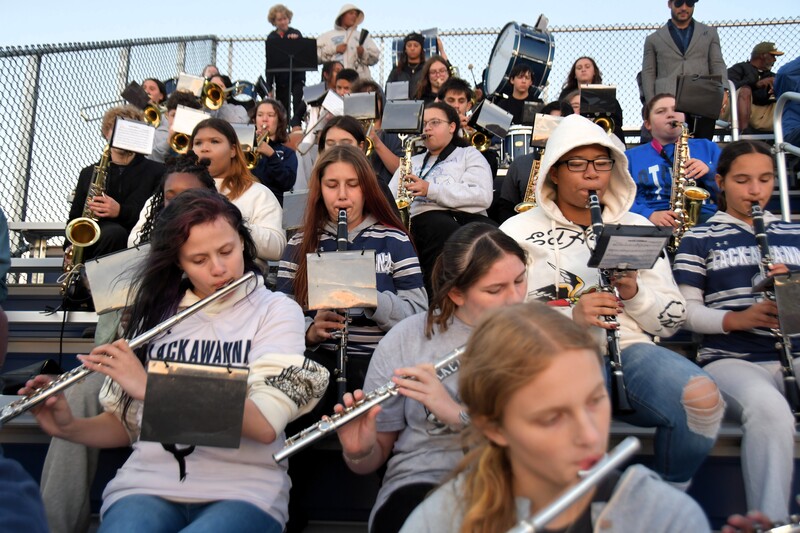 band students sit and play in stands