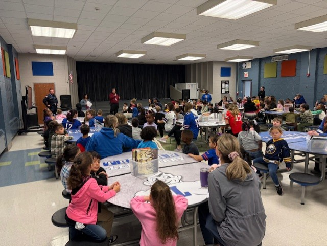 Families gather in cafeteria.