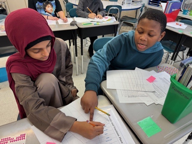 Students work on math in class.