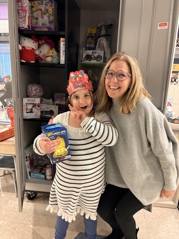 Student poses for a photo with teacher.