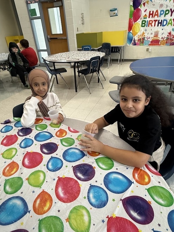 Students play at birthday celebration.