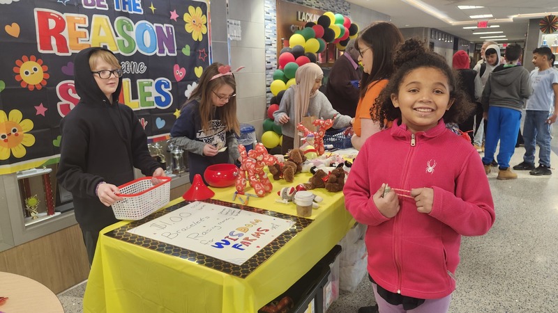 Students work on bracelets to donate.