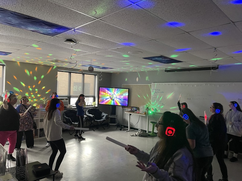 Staff have fun at a silent disco.