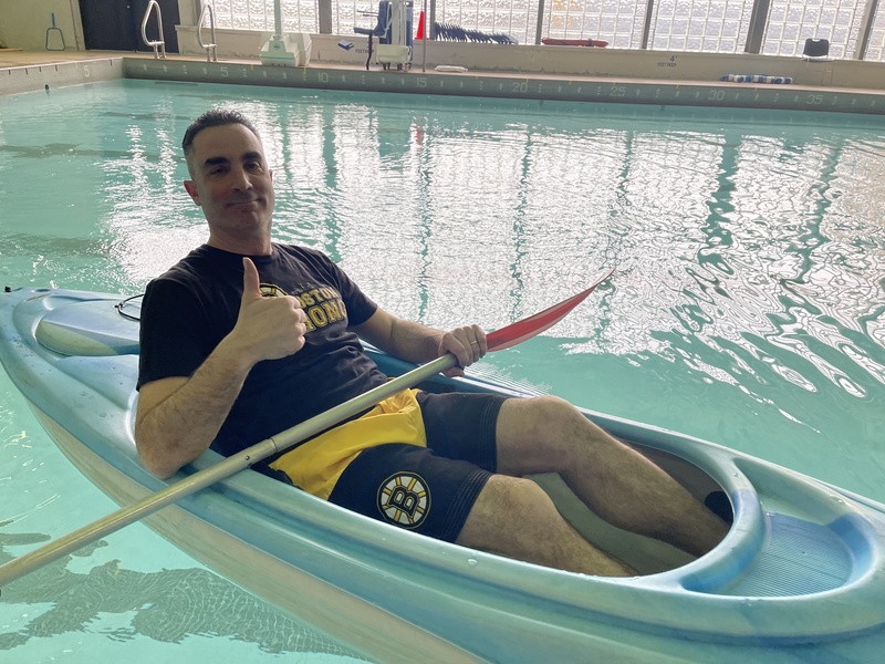 Teacher kayaks in the pool.
