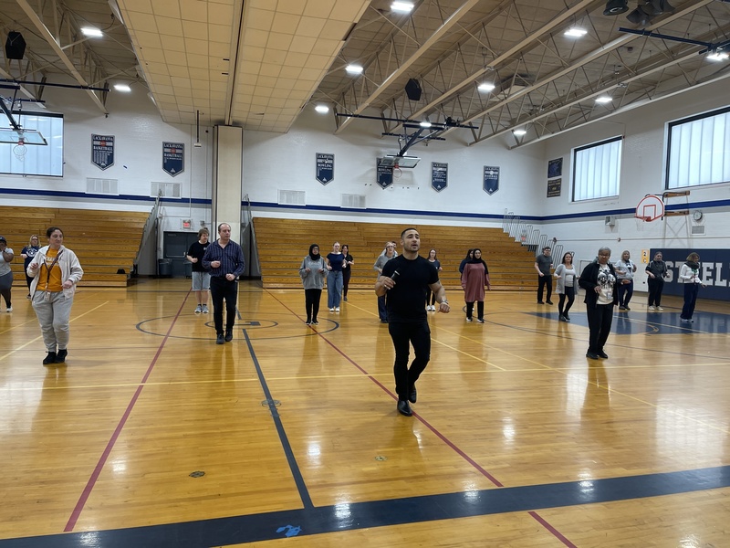 Mr. Rice instructs staff in Salsa dancing.