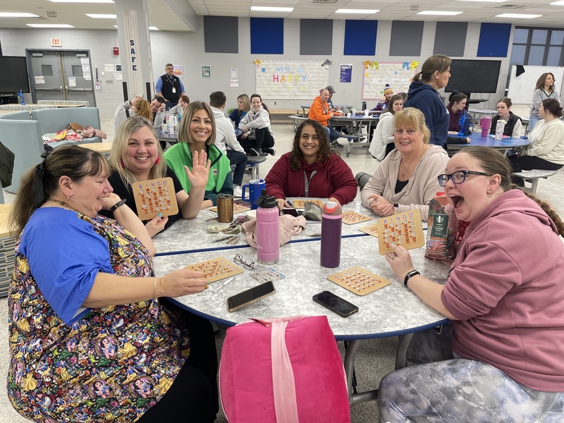 Teachers pose with their bingo boards.