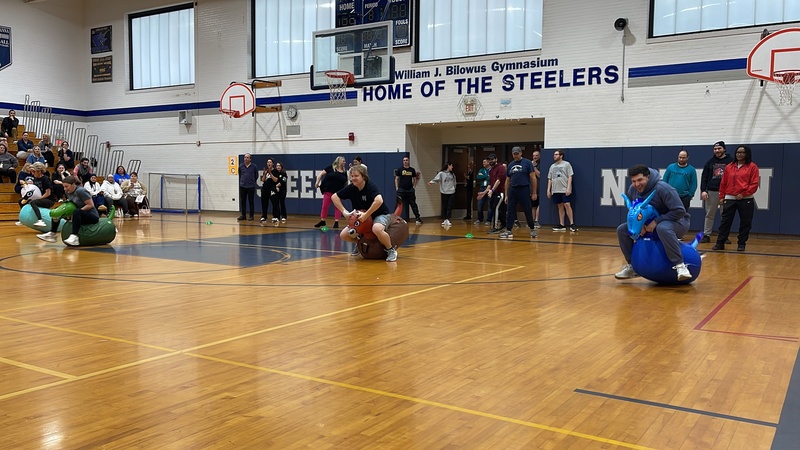 Teachers race on inflatable animals.