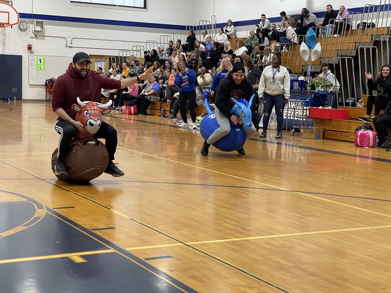 Teachers race on inflatable animals.