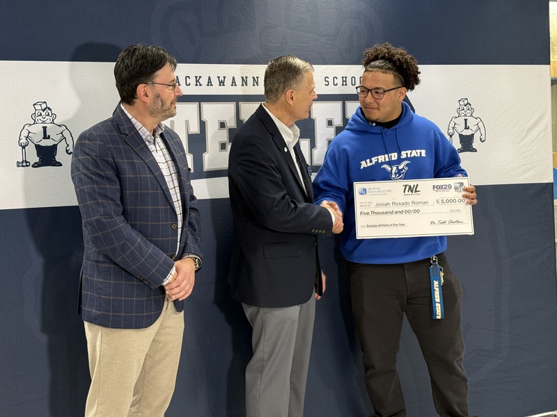 Jossiah receives his scholarship check.