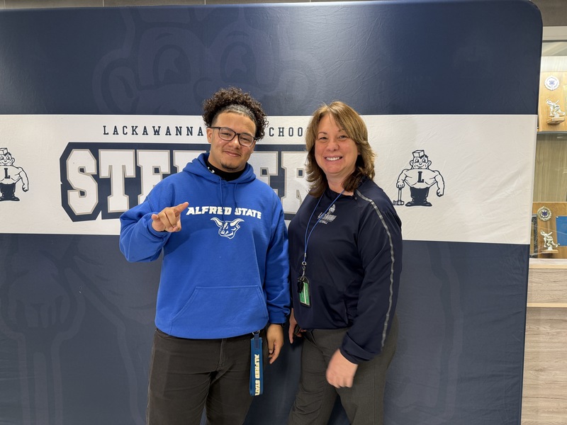 Jossiah poses for a photo with Athletic Director Amy D'Amato