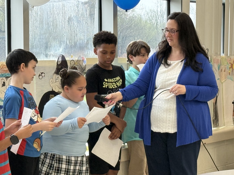 Students speak at playground opening ceremony.