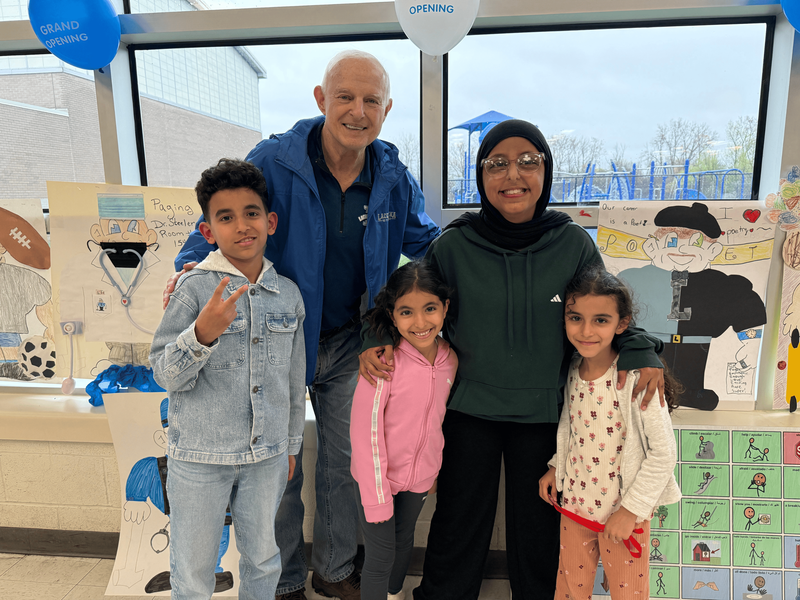 Mr. Sanders stands with students.