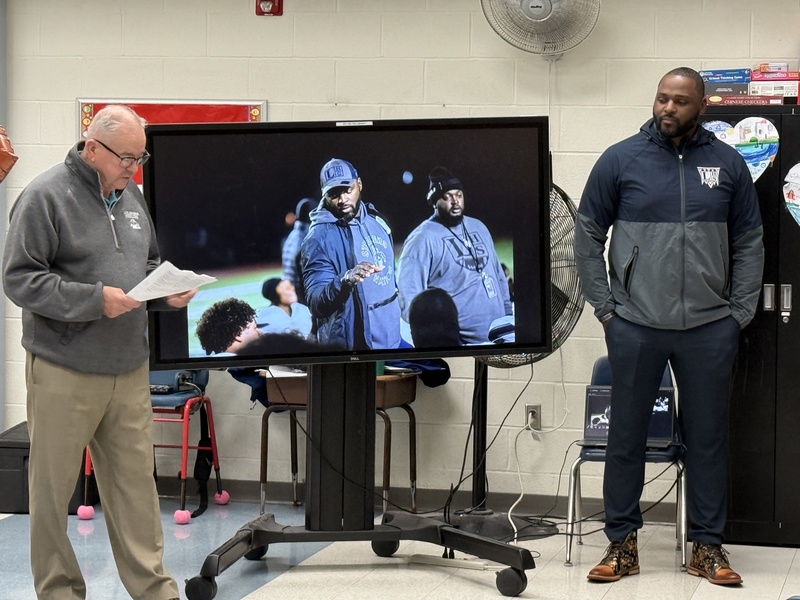 Paul Lyons  stands with Marcus Rivers.