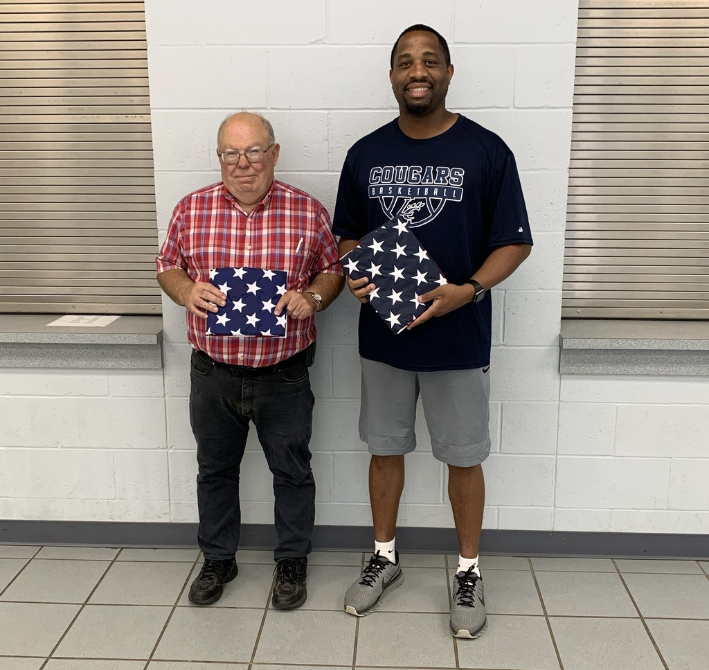 Mr. Goodwin and Coach Briggs with donated flags