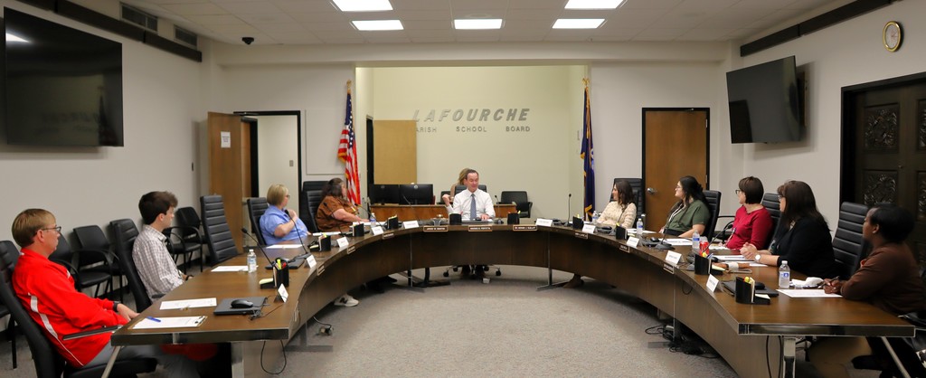 The members of the Employee Advisory Council sit around a horseshoe shaped table with the Superintendent.