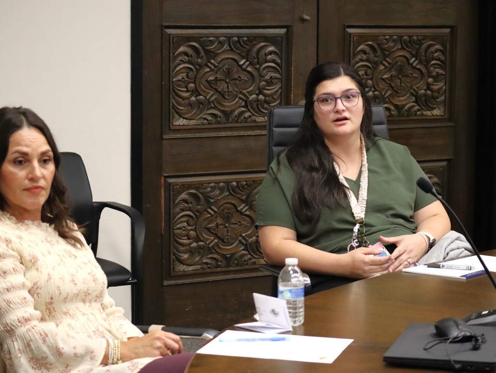 Two female employees participate in the Employee Advisory Council meeting.