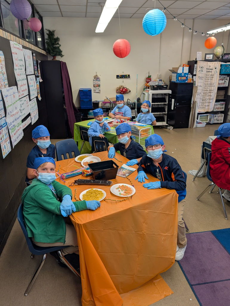 Students looking at camera while doing work. 