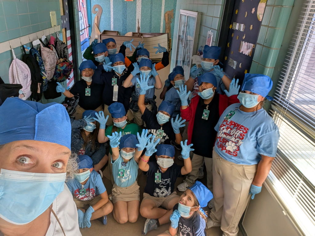 Teacher and students take a group photo together. 