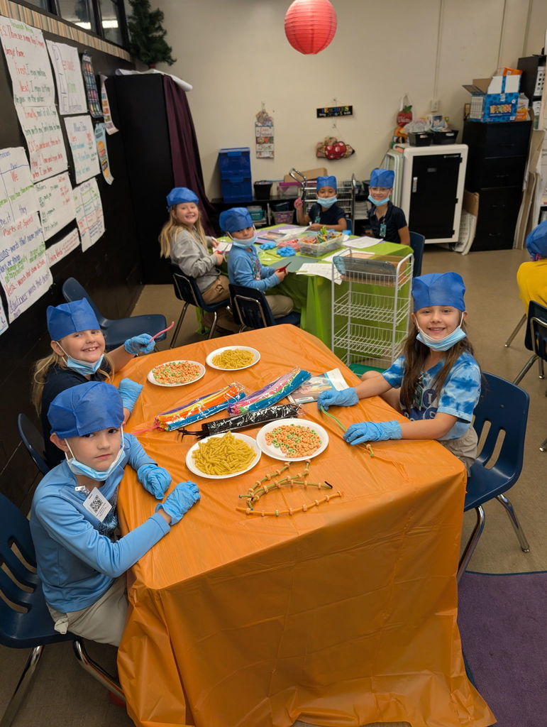 Students looking at camera while doing work. 