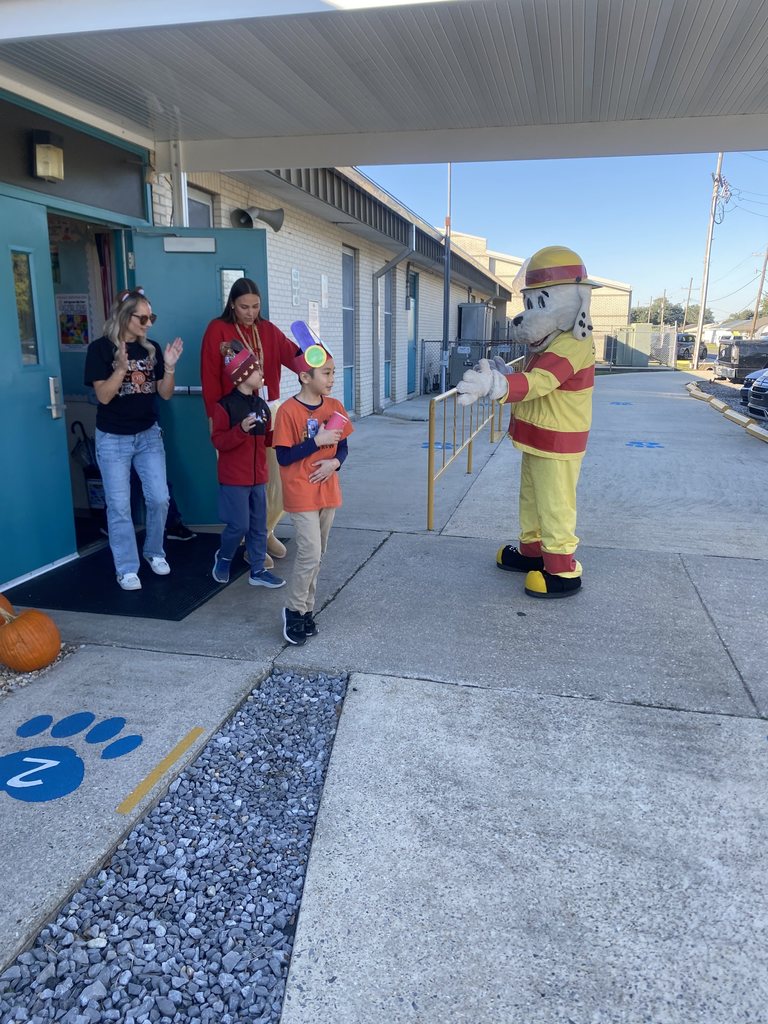 Kids walking out door for parade.