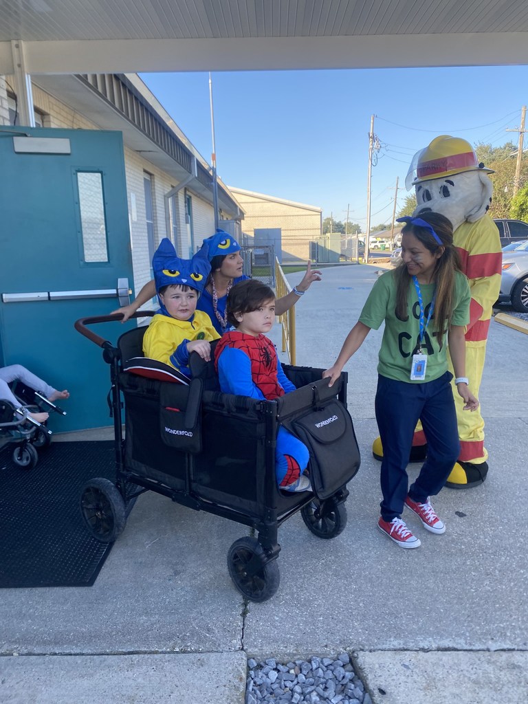 Kids walking out door for parade.