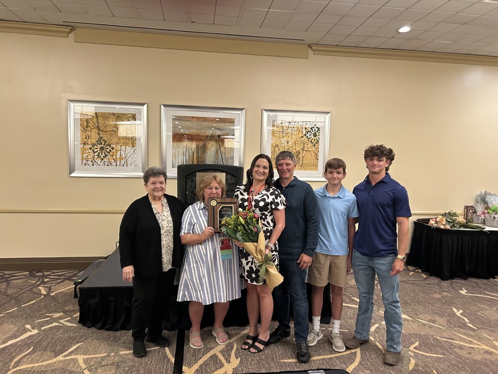 Dawn Breaux receiving the Louisiana Educational Diagnostician of the Year Award with her family