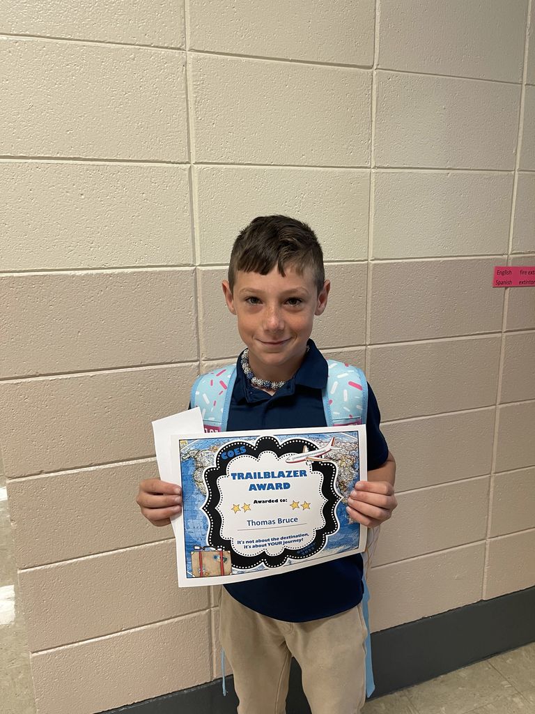 Student with award certificate. 