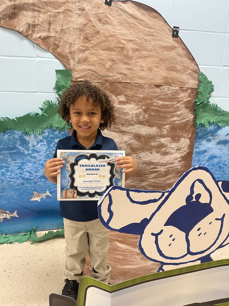 Student with award certificate. 