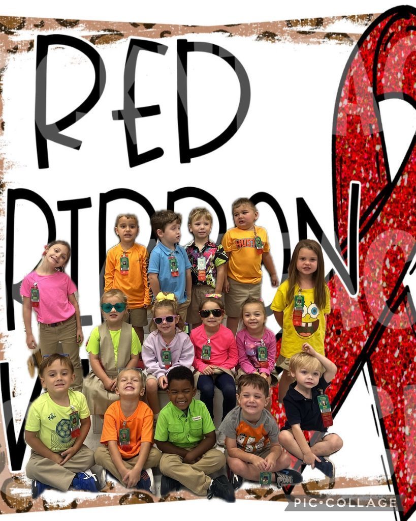 Group of children wearing bright, colorful shirts and khaki bottoms posing in front of a backdrop that says “RED RIBBON” with a large glittery red ribbon, celebrating Red Ribbon Week.