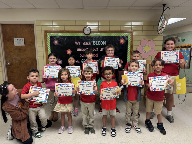 November Student of the Month recipients holding certificates.
