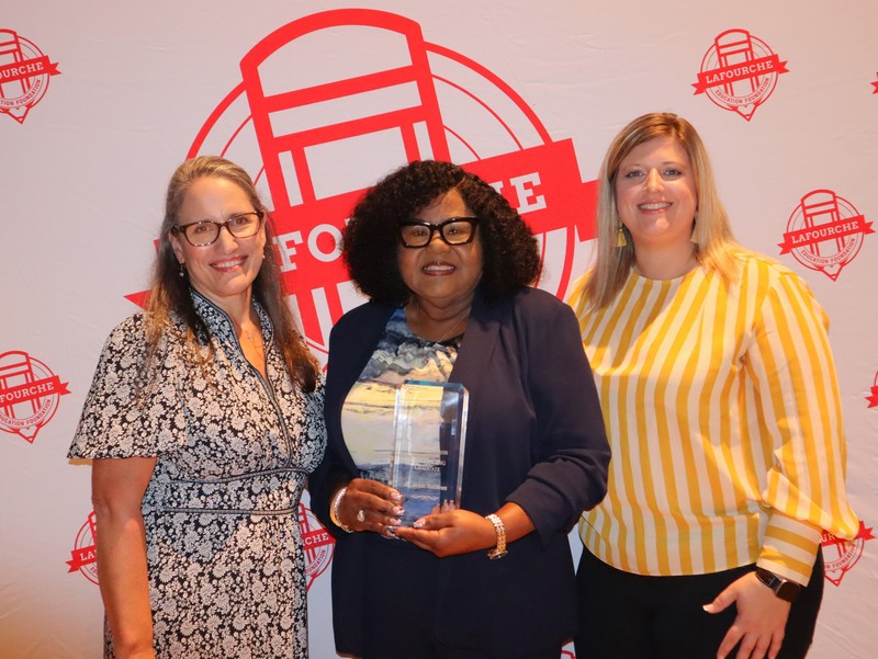 Dr. Joann Matthews receives the Outstanding Graduate award from  LEf president Brokke Beryy and Dr. Mary Breaud, LEF past president.