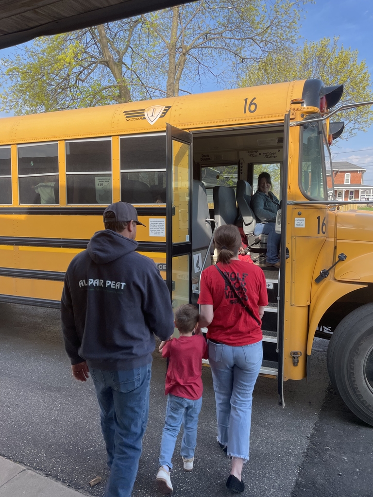 Kindergartener and family boarding the bus