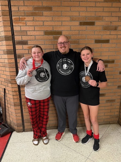Addy  with her coach and sister holding metals