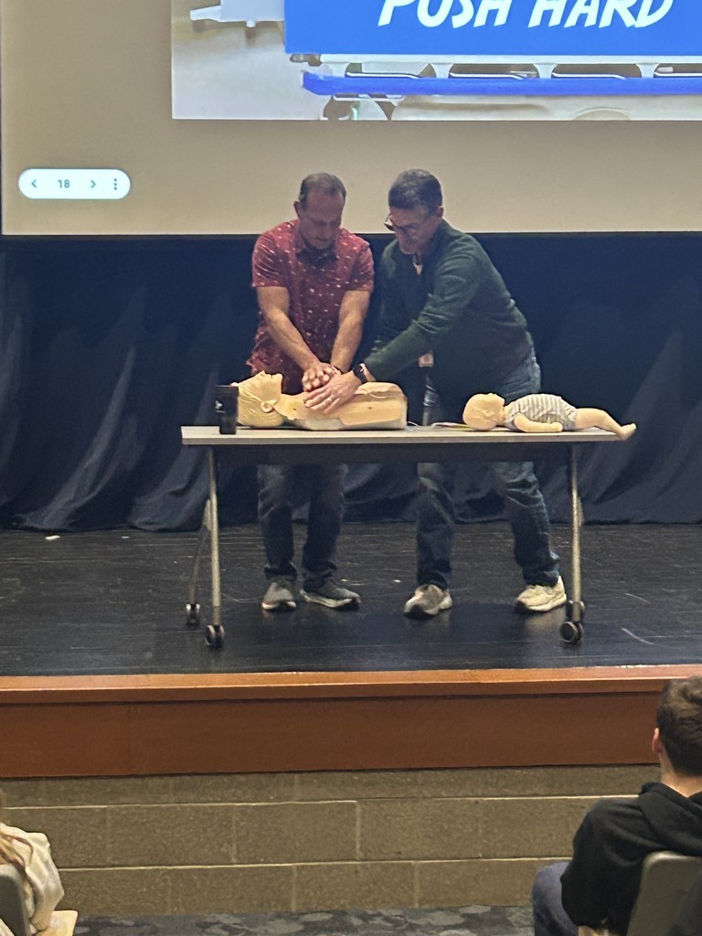 Teachers performing CPR on dummy