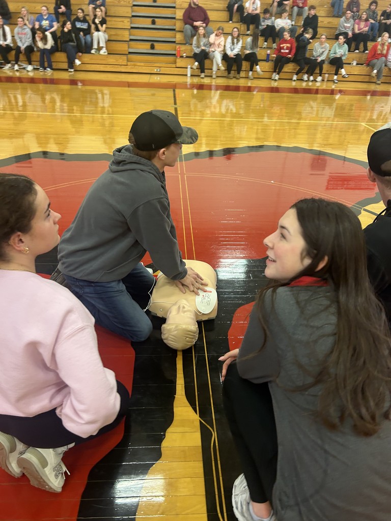 Students performing CPR on dummy