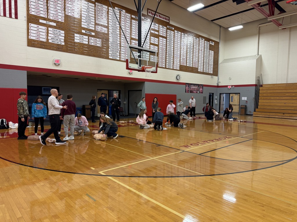 Students performing CPR on dummy
