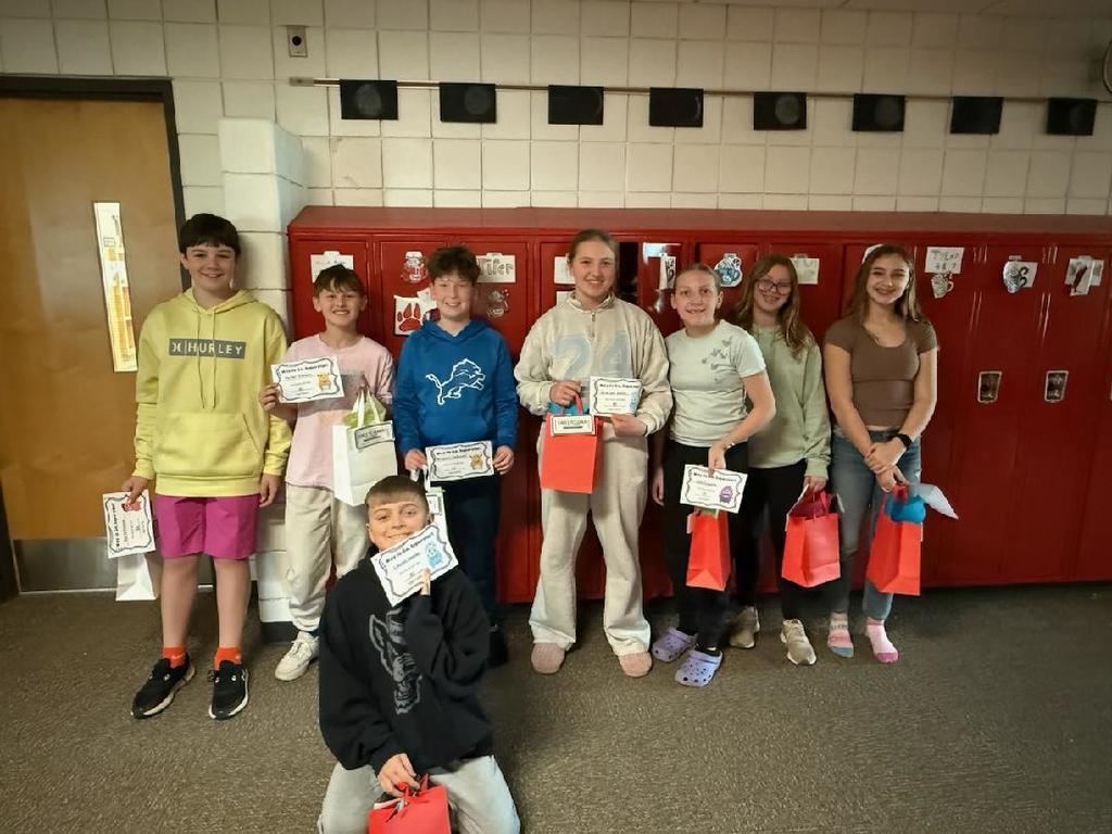 Students standing in front of lockers for a picture. 