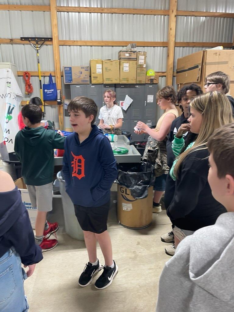 Students listening to speaker at recycling center