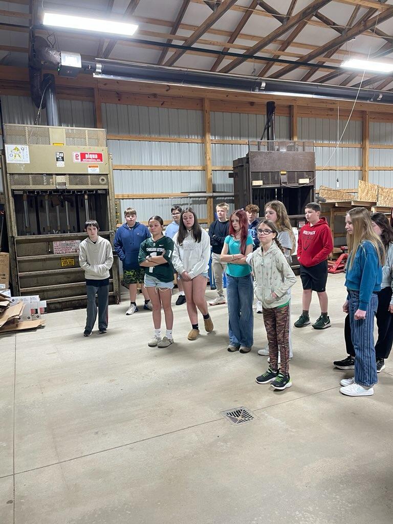 Students listening to speaker at recycling center