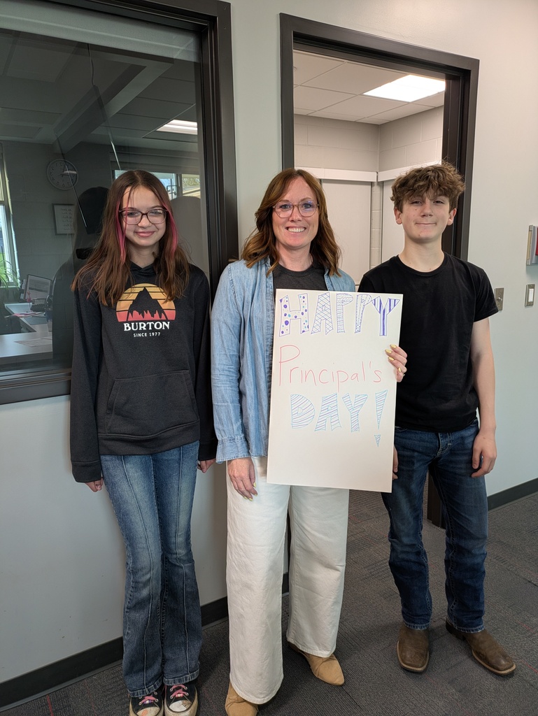 Principal with two students and handmade card
