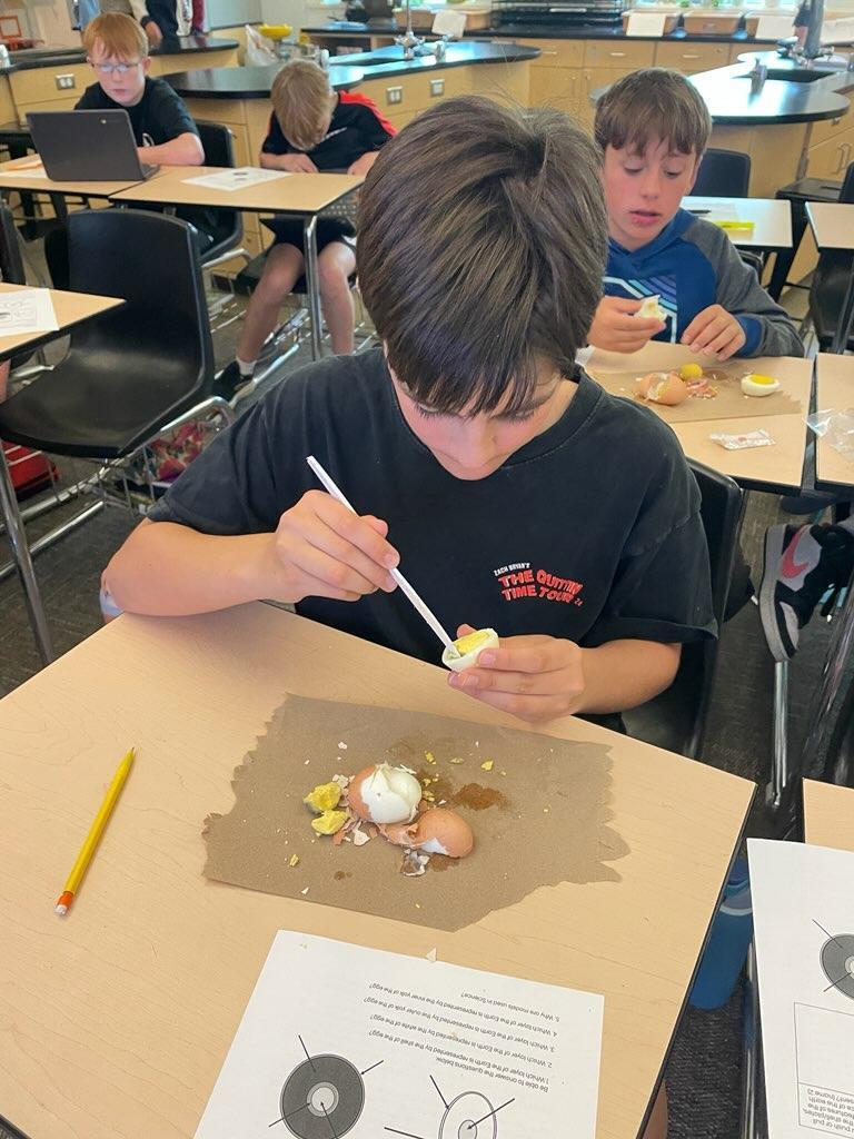 Student inspecting hard boiled egg
