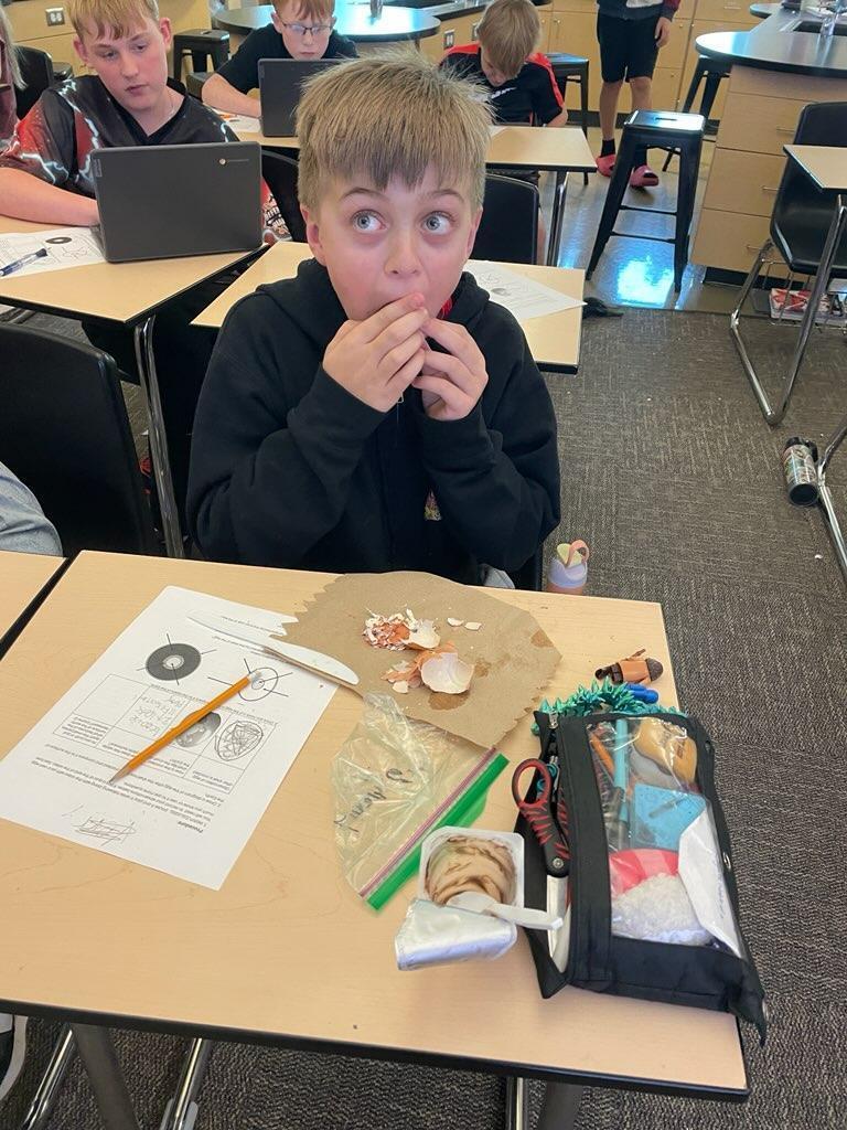 Student inspecting hard boiled egg