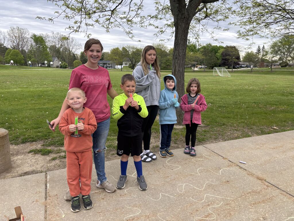 Kids playing outside and eating popsicles