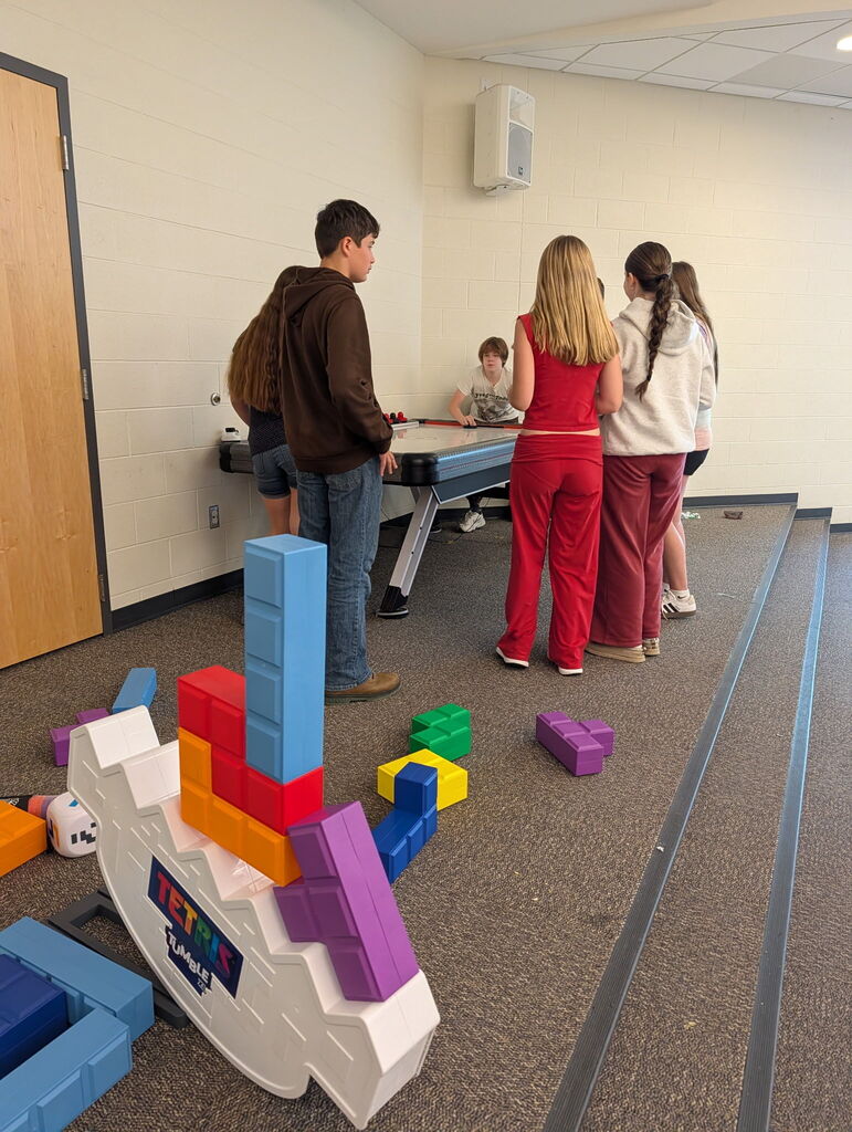 Students playing air hockey