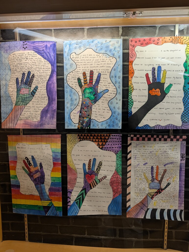 Display case with 6 student zendoodle handprint drawings