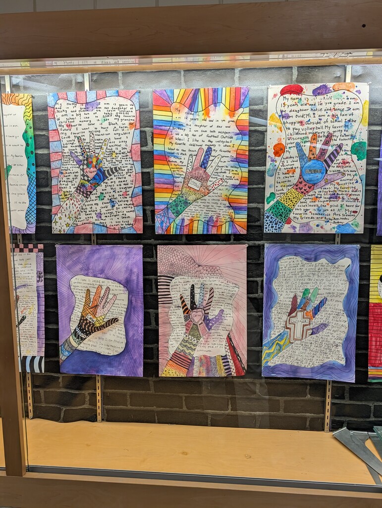Display case with 6 student zendoodle handprint drawings