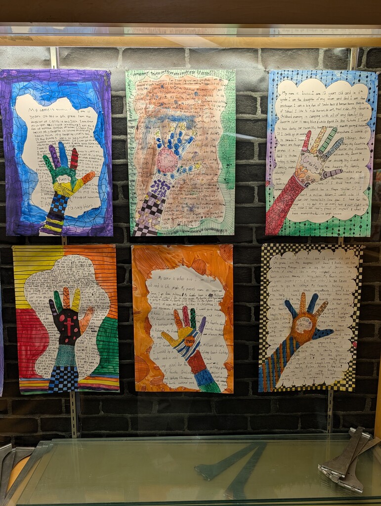 Display case with 6 student zendoodle handprint drawings