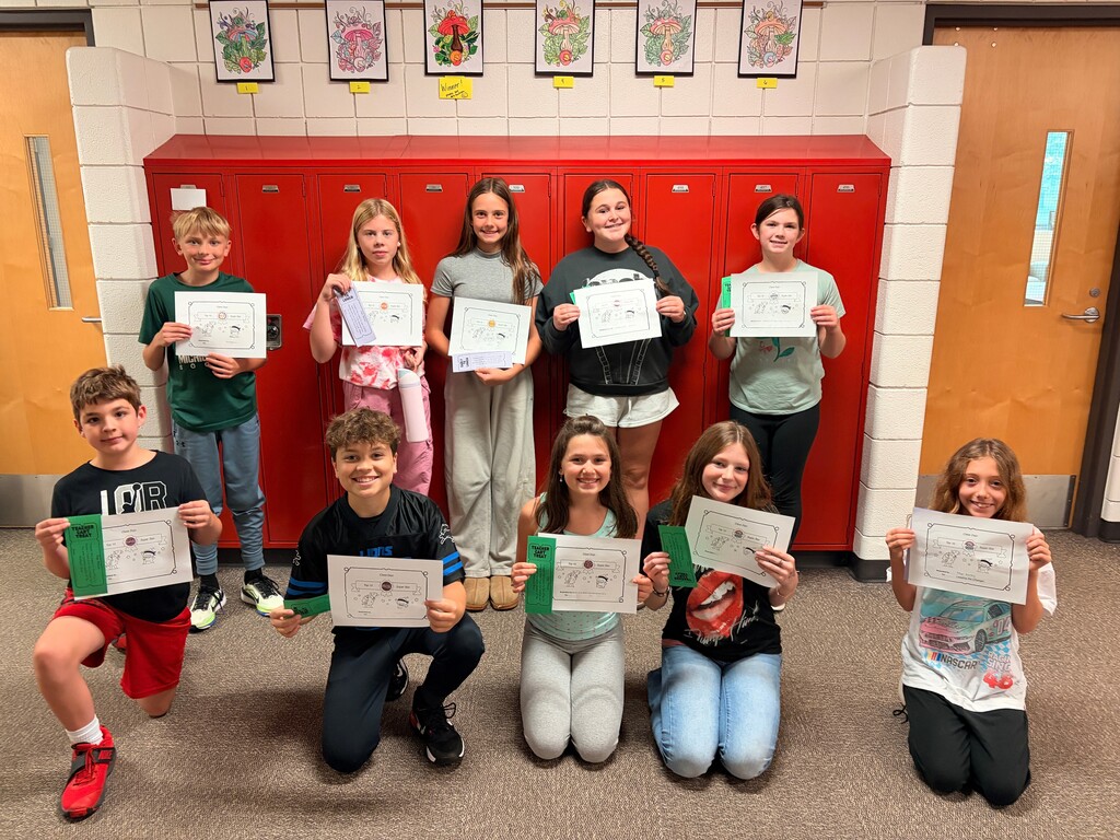 Students holding awards in front of lockers