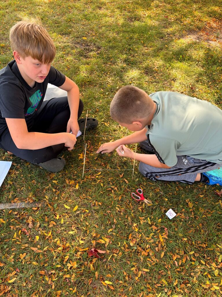 Students surveying the ground in STEM class
