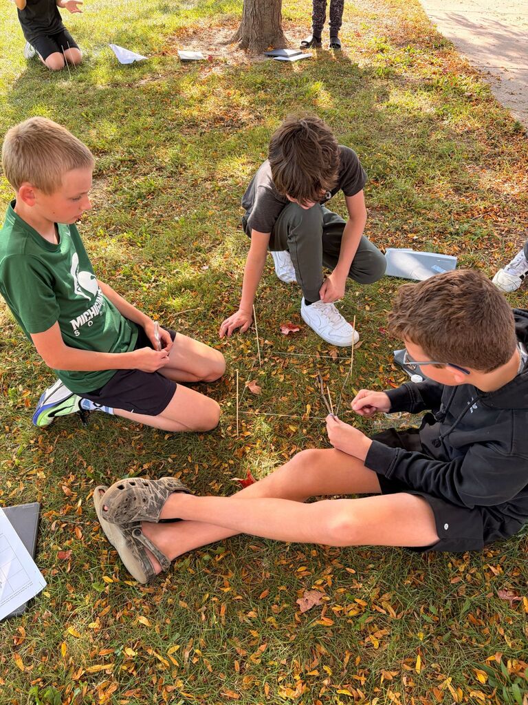 Students surveying the ground in STEM class